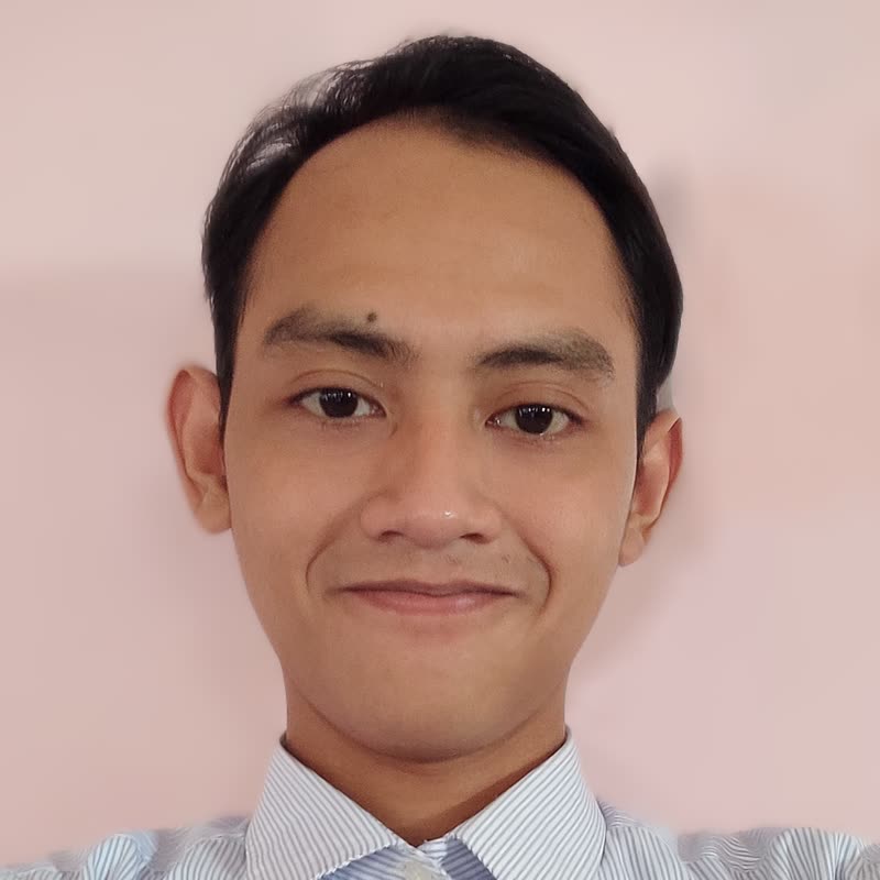 Portrait of Ayip Taqiyyudin, smiling, in a striped shirt